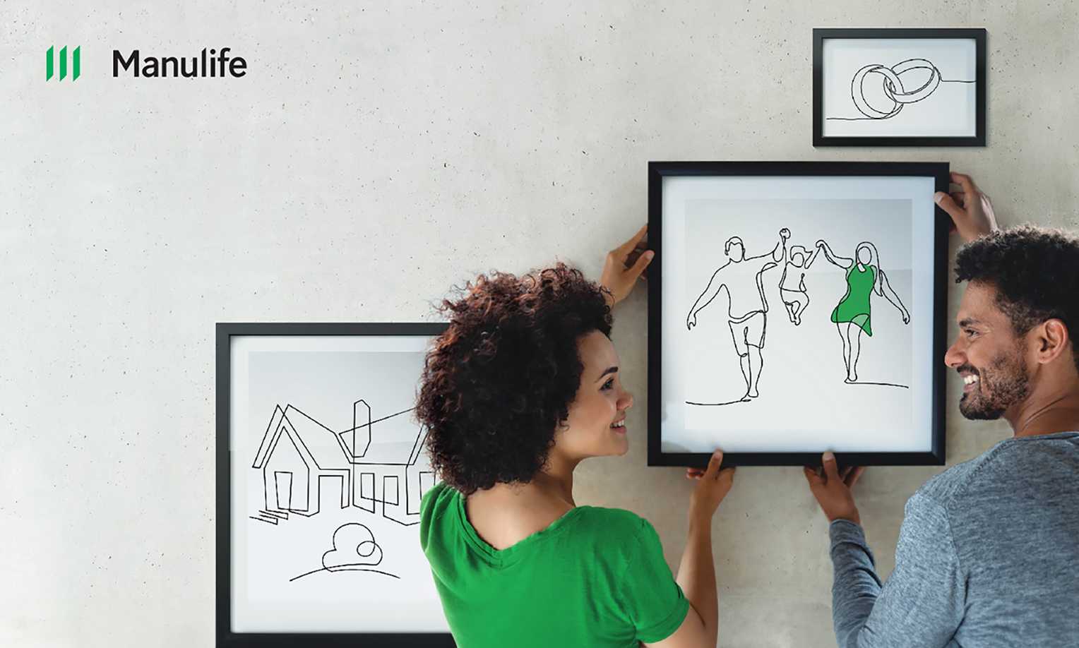 A smiling couple hanging framed minimalist line drawings of a house, family, and wedding rings on a wall, with a Manulife logo in the upper left corner.